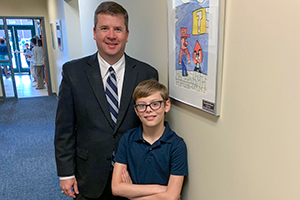 Superintendent Dr. Andrew Houlihan with Marshville Elementary student Jeremiah Moore at Art Showcase
